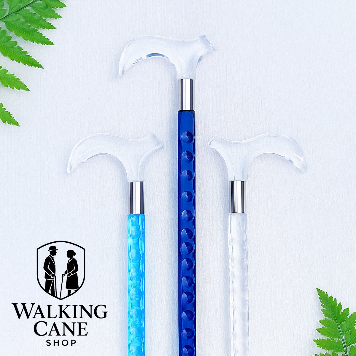Three walking canes with blue, clear, and white handles on a light background