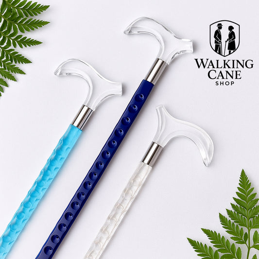 Three walking canes with decorative handles on a white background